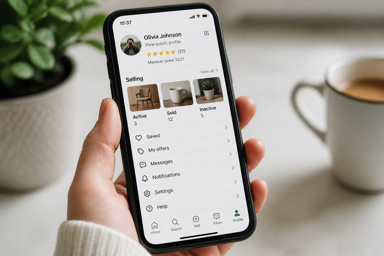 Main tenant un smartphone affichant le menu paramètres d'une application de vente entre particuliers